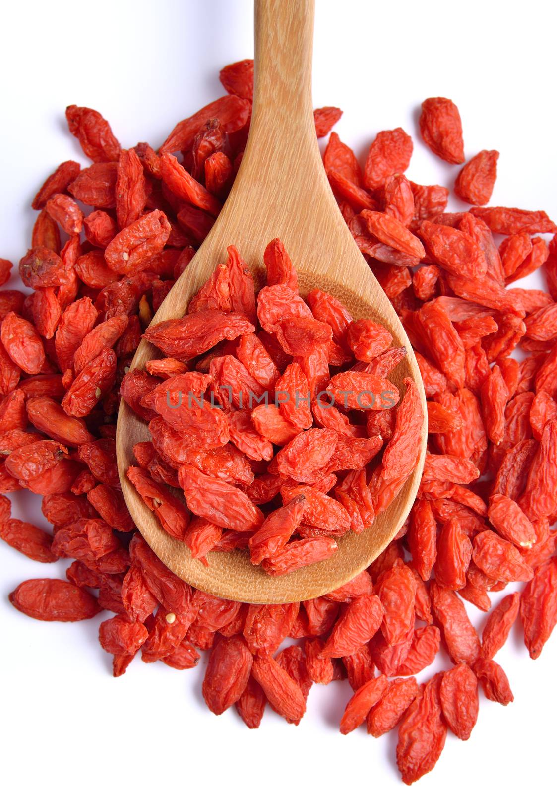 dry red goji berries  in the spoon on white background by sommai