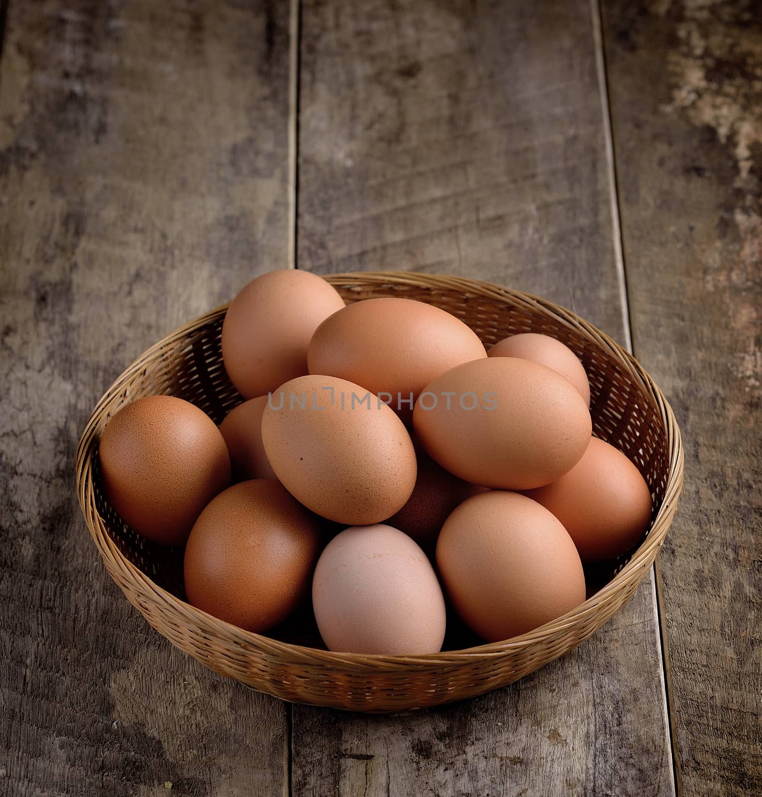  egg in a basket on wodden table