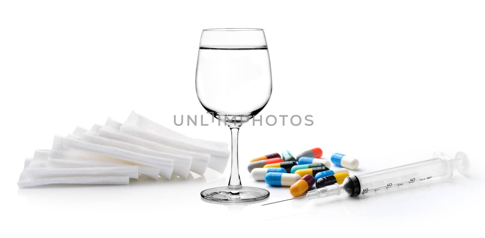 Glass of water  syringe pill and Cotton bandage on white backgro by sommai