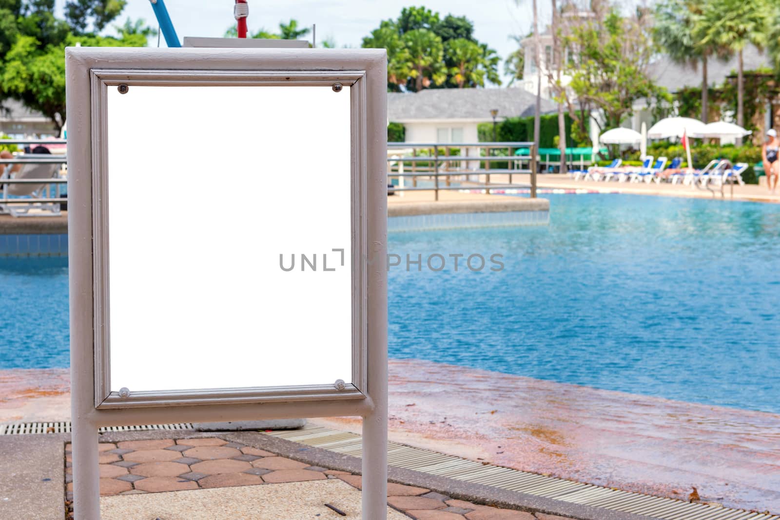 empty of sign standing near a swimming pool.