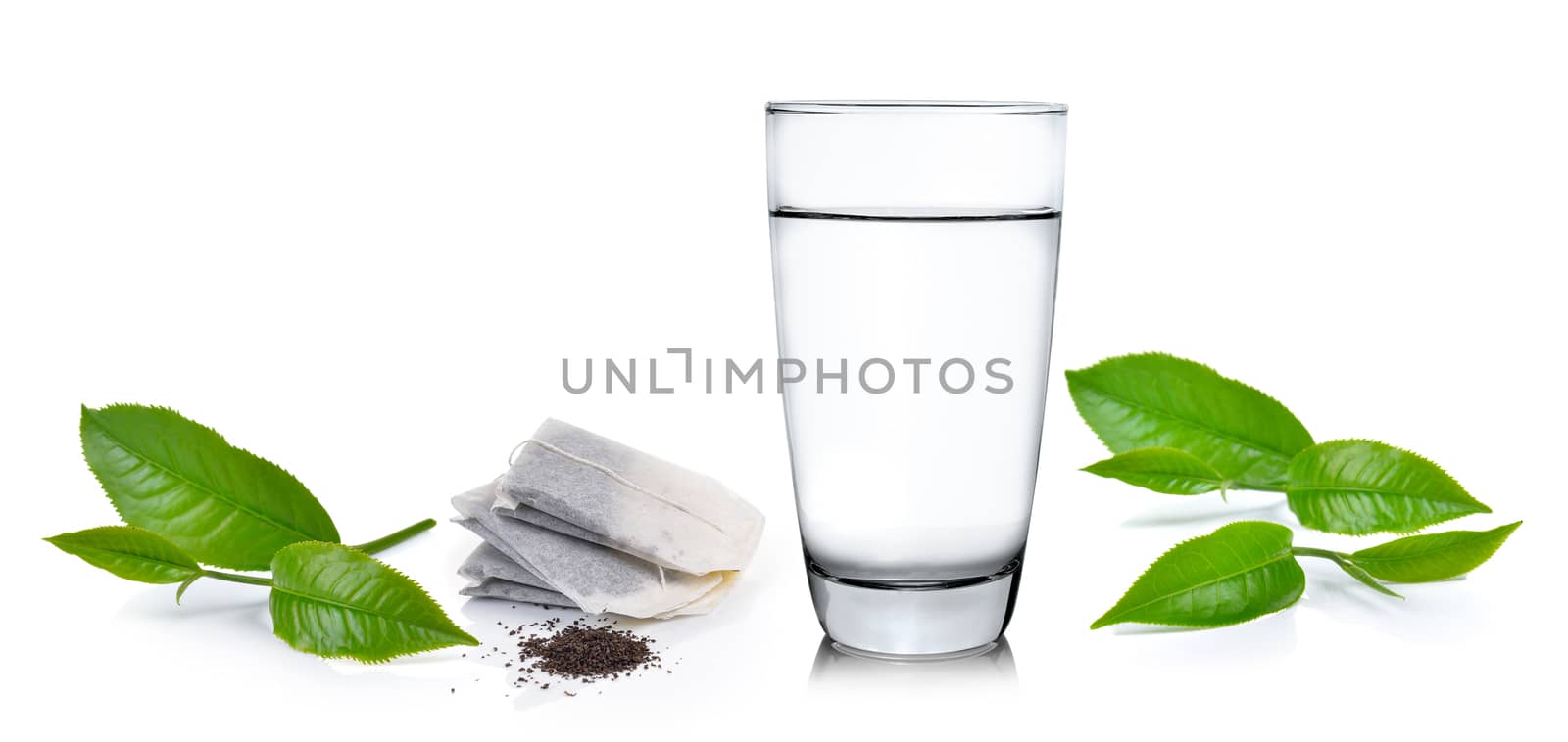 Glass of water and tea leaves ilsolated on white background