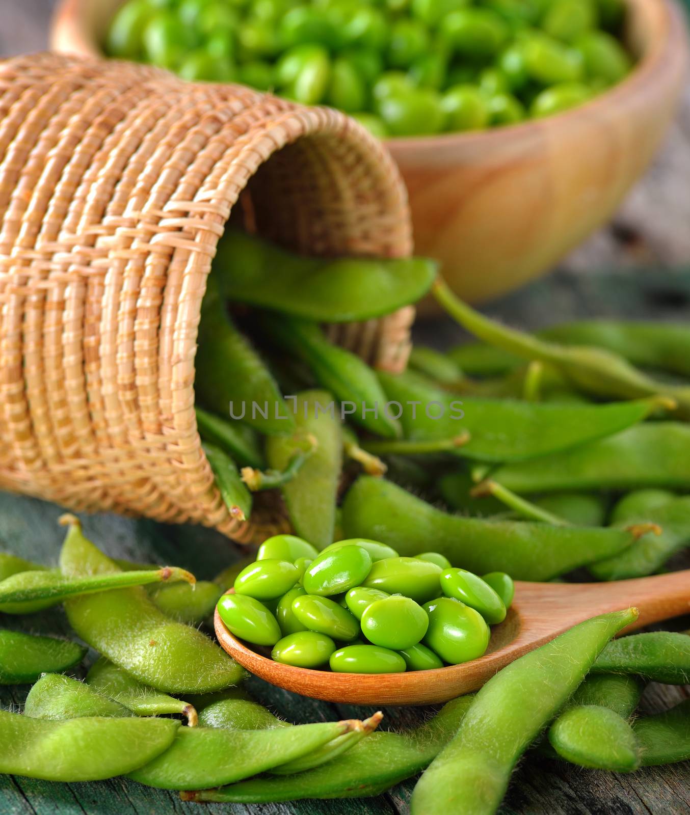 green soy beans in the wood bowl on table by sommai