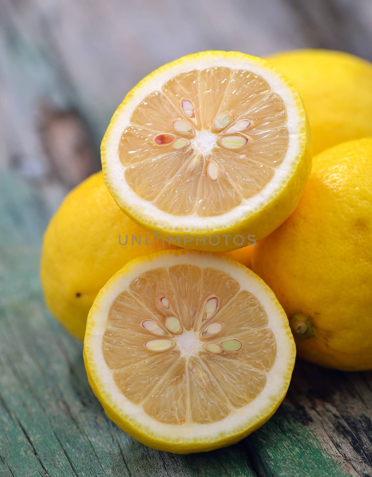 Fresh lemons on wooden table by sommai