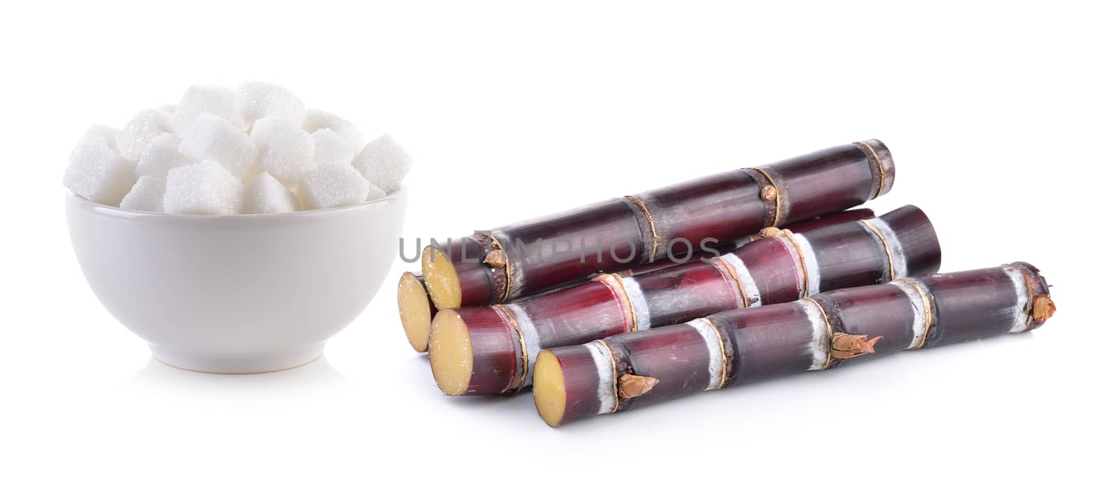 sugarcane and sugar cube on white background