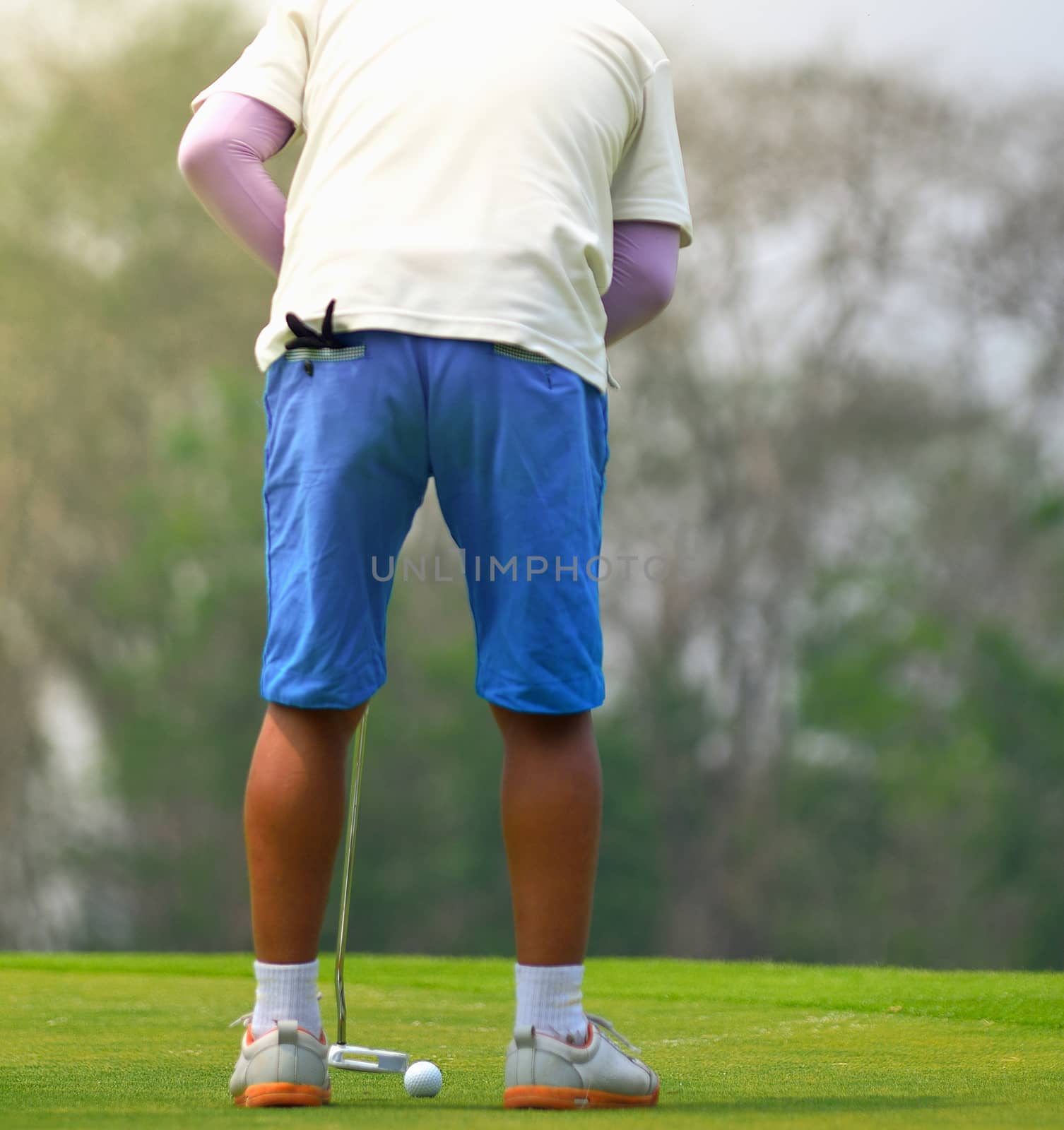 Man playing golf by sommai