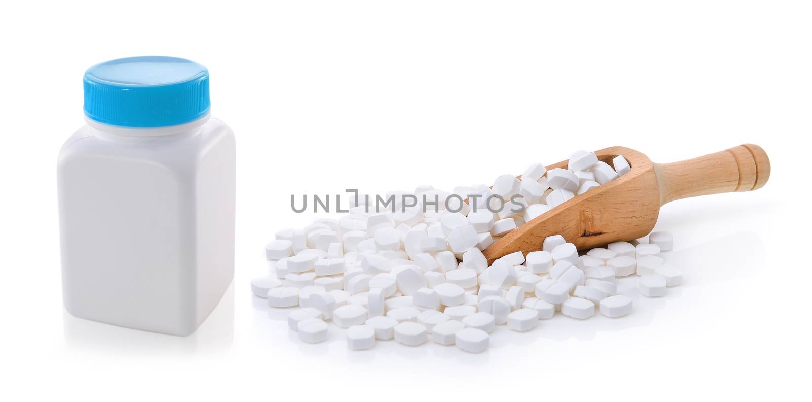 pills out of bottle on white background by sommai