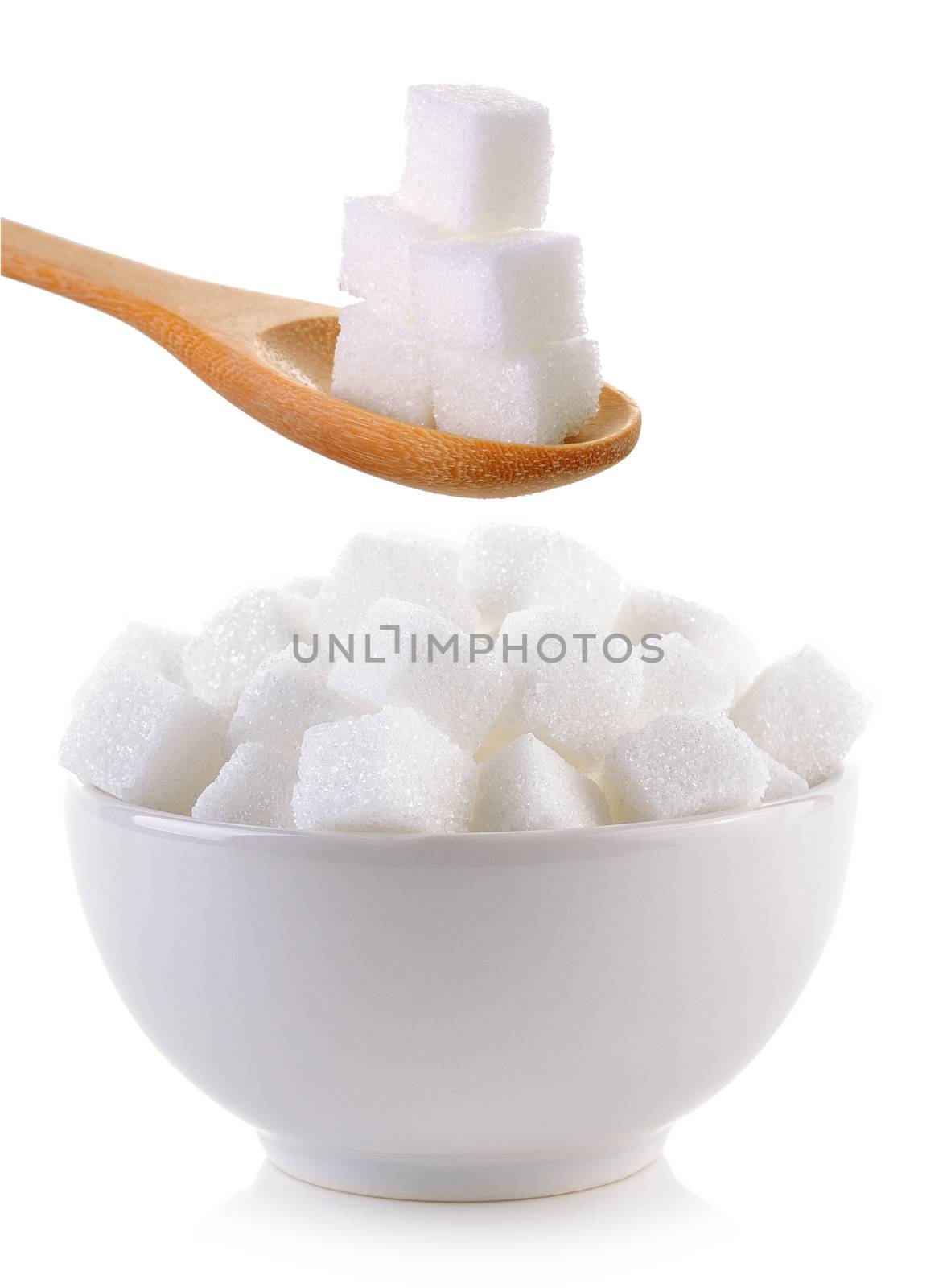 sugar cube in the bowl and wood spoon on white background by sommai