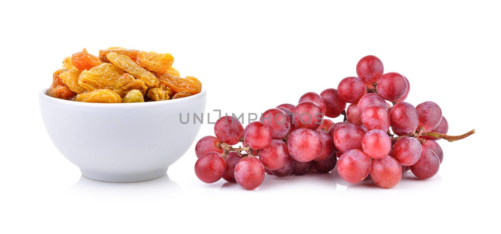 raisin in the white bowl and grape on white background by sommai