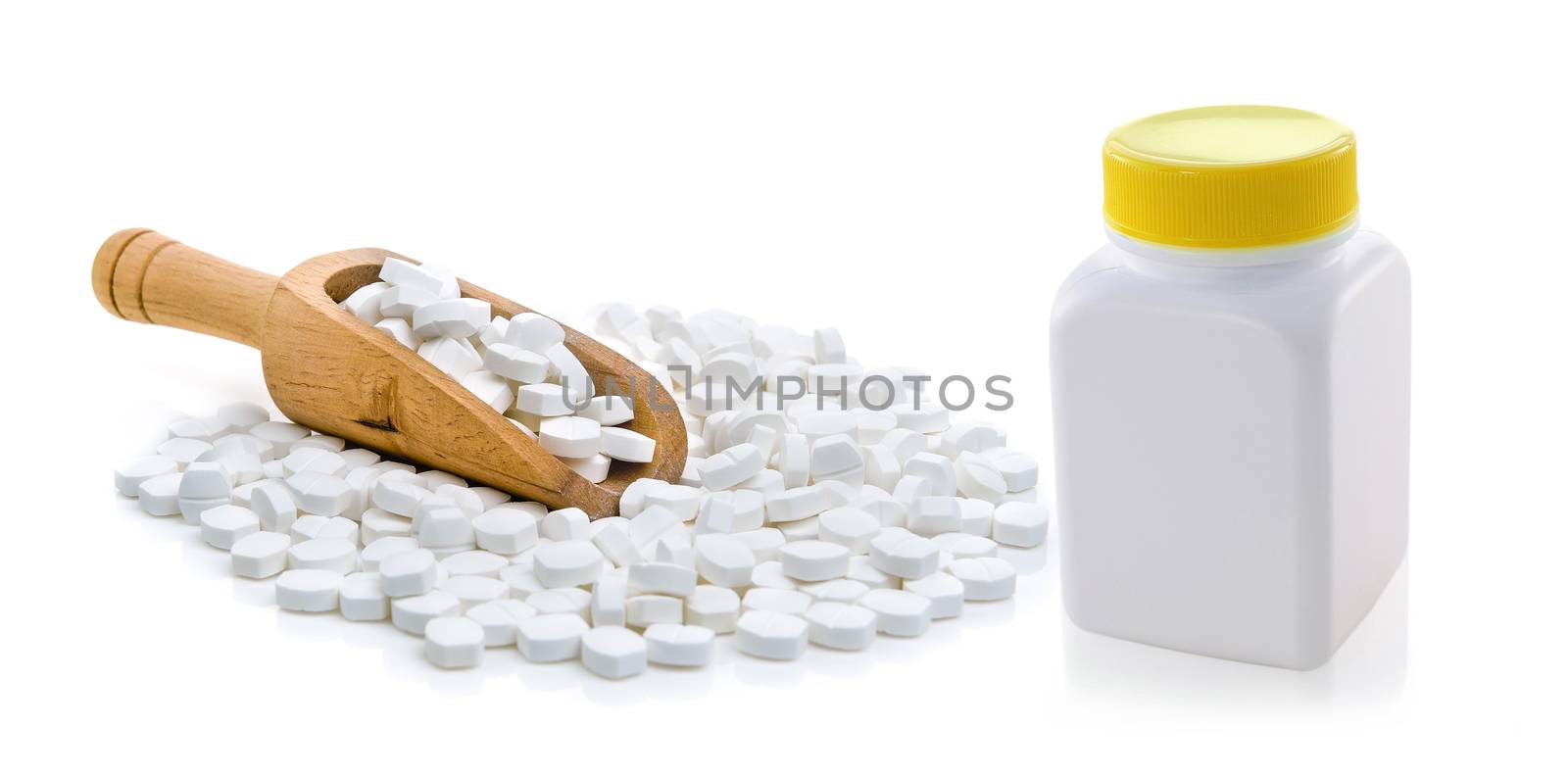 Pills spilling out of pill bottle by sommai