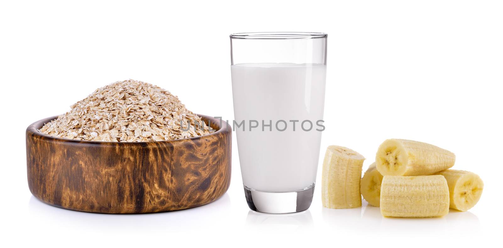 Oat flakes, banana and milk on white background by sommai