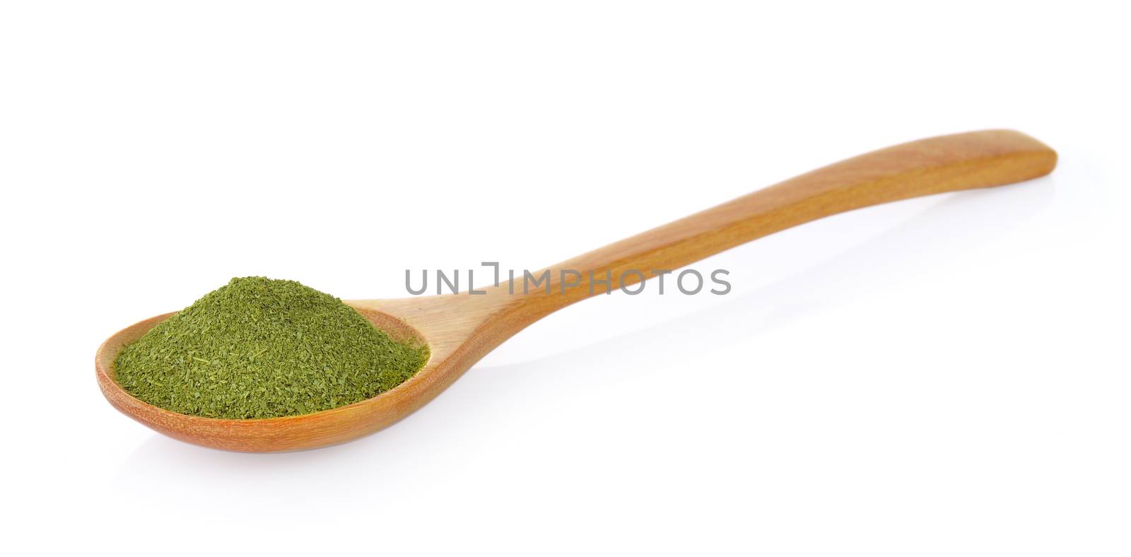 dry green tea in wood spoon by sommai
