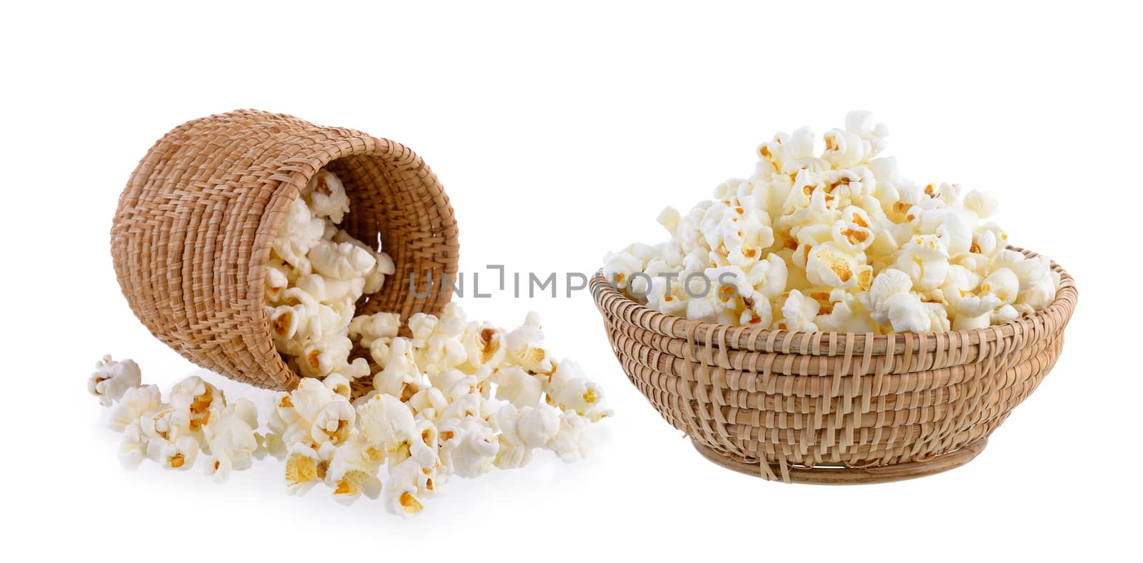 popcorn in basket isolated on white background by sommai