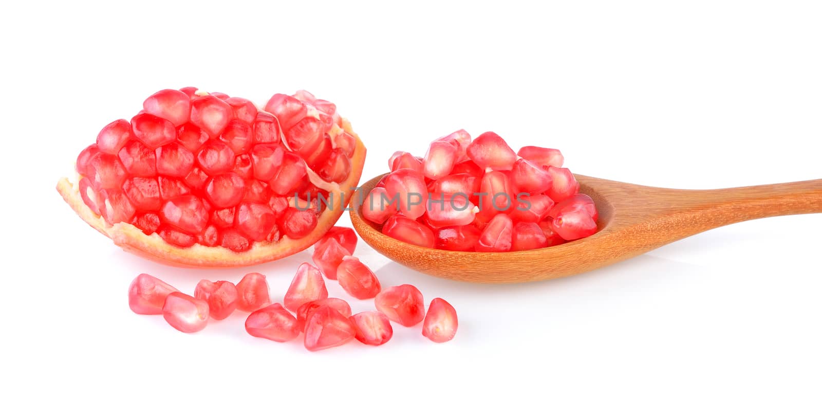 Pomegranate fruit seeds on white background by sommai