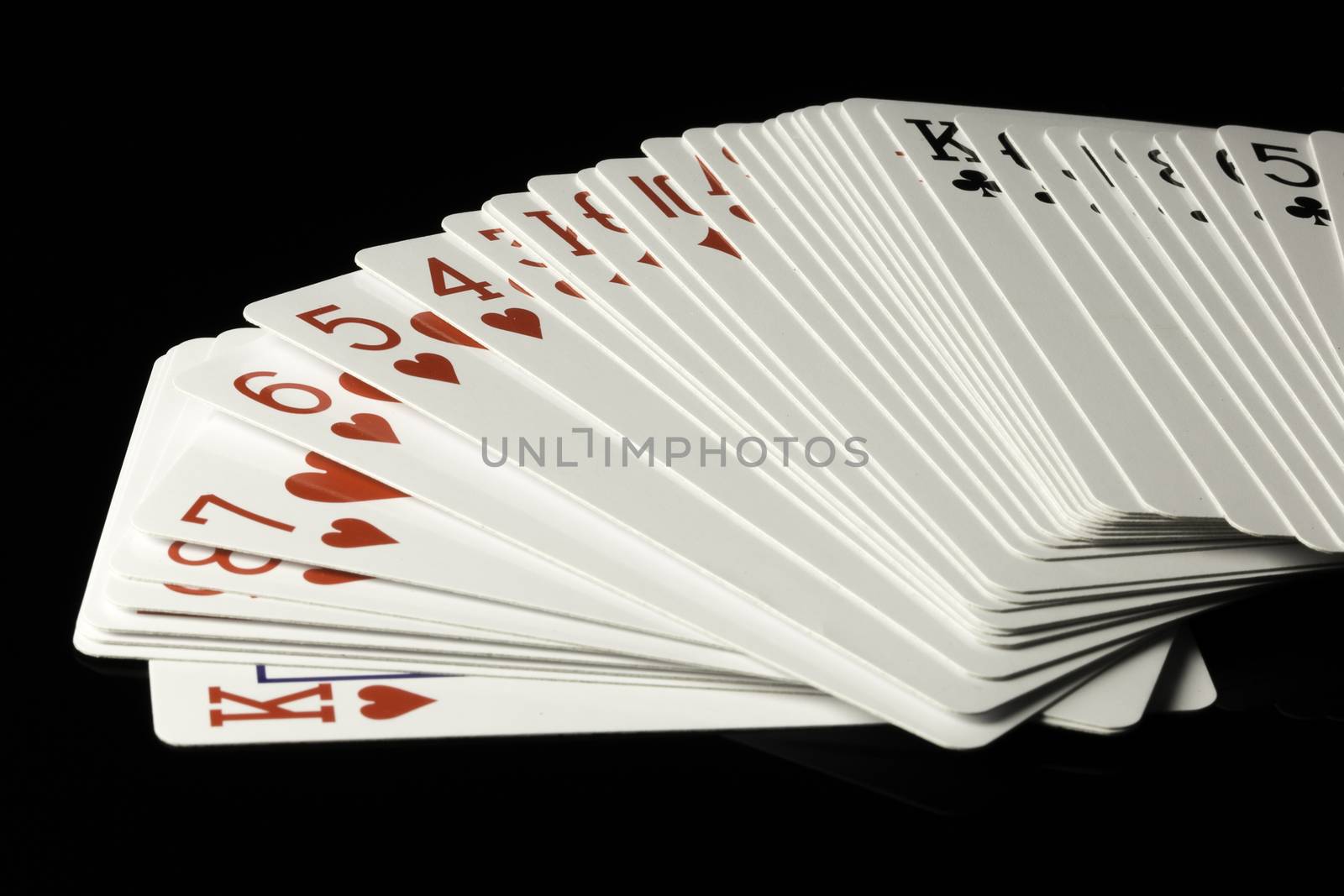 Playing Cards Spread Out on black background.