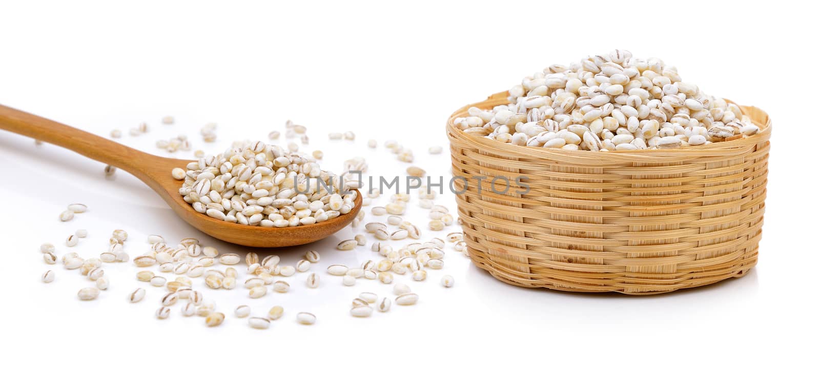 Barley Grains in the basket and wood spoon on white background by sommai