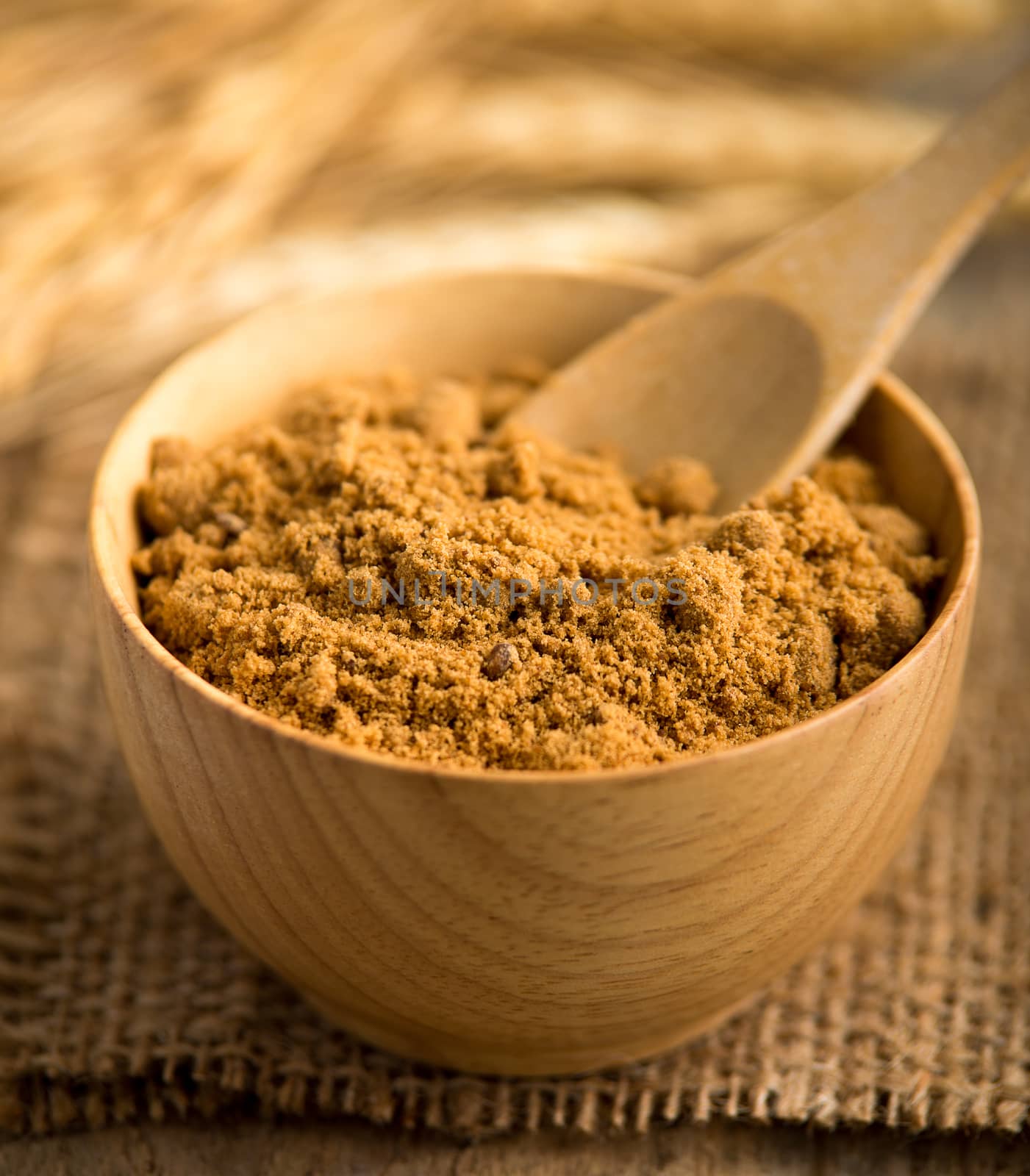 coconut palm sugar against an out of focus  by sommai
