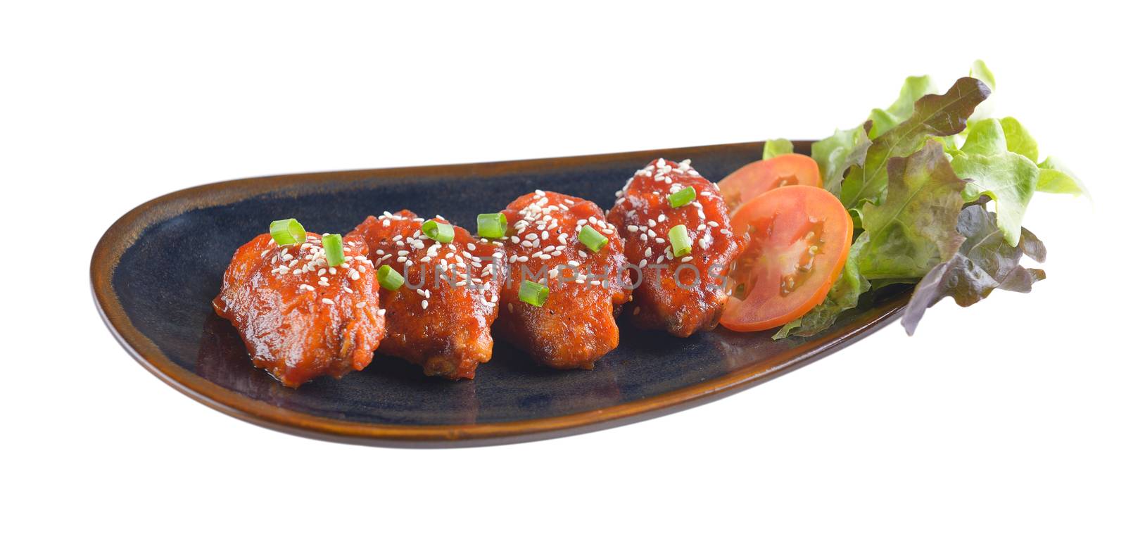 Chicken wings with sauce in ceramic plate on white background by sommai