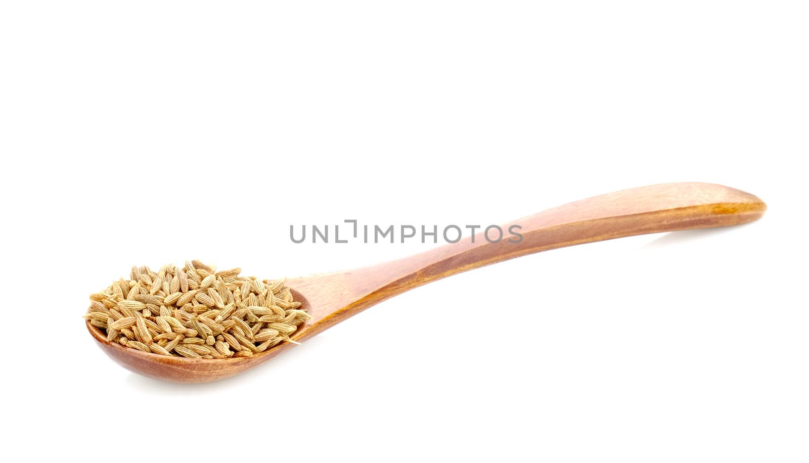 Cumin seeds in wood spoon on white background.