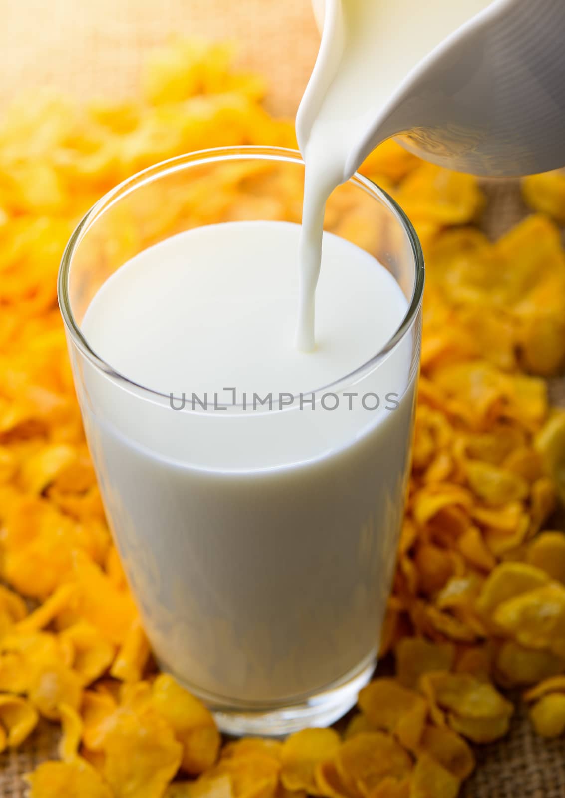 Milk pouring from a jug into a glass 