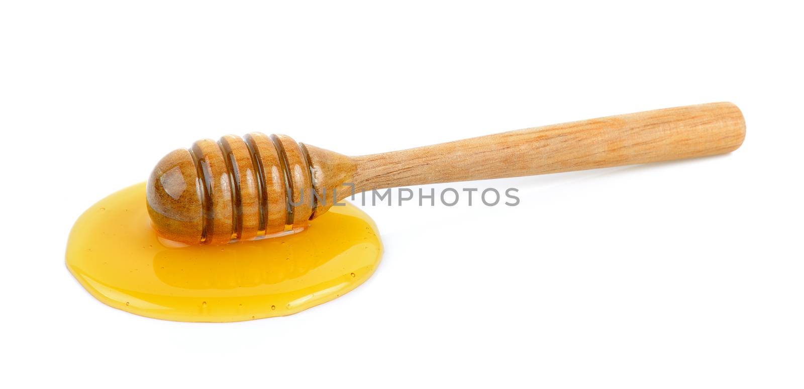 Wooden honey dipper with honey by sommai