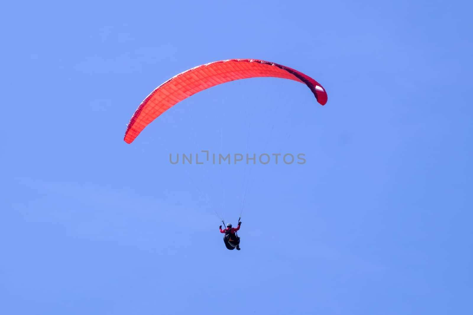 Paraglider in the blue sky at the Kampenwand in Bavaria, Germany
