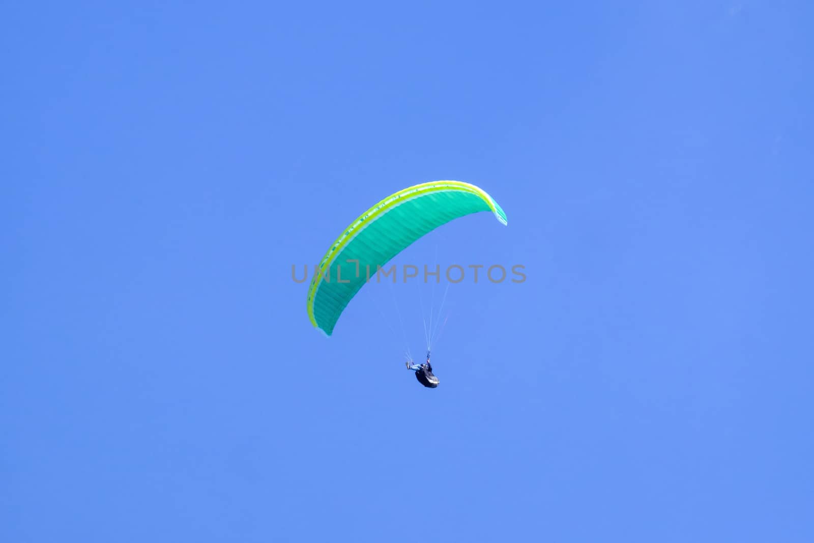 Paraglider in the blue sky at the Kampenwand in Bavaria, Germany