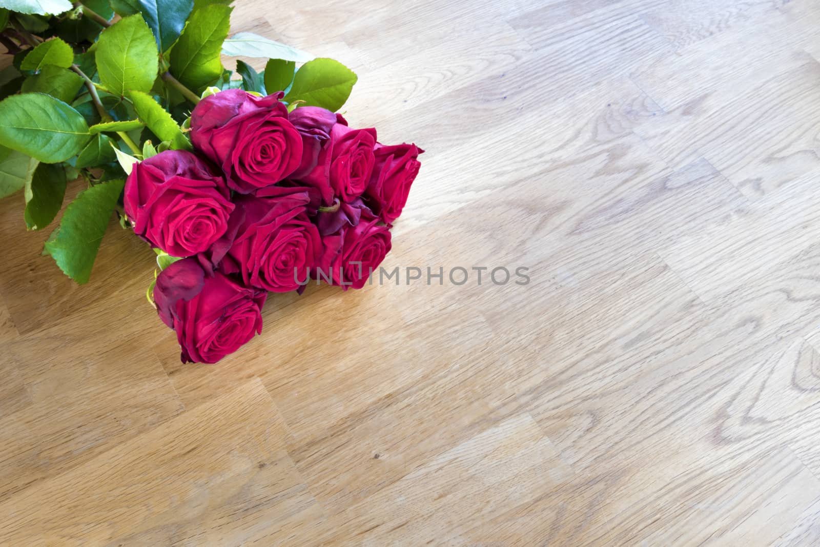 Red roses on a wooden table