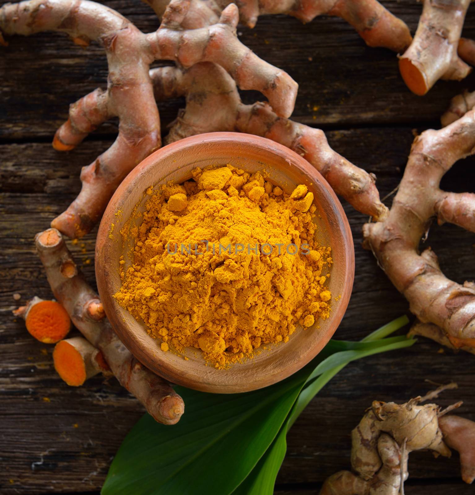 Turmeric powder on wooden background