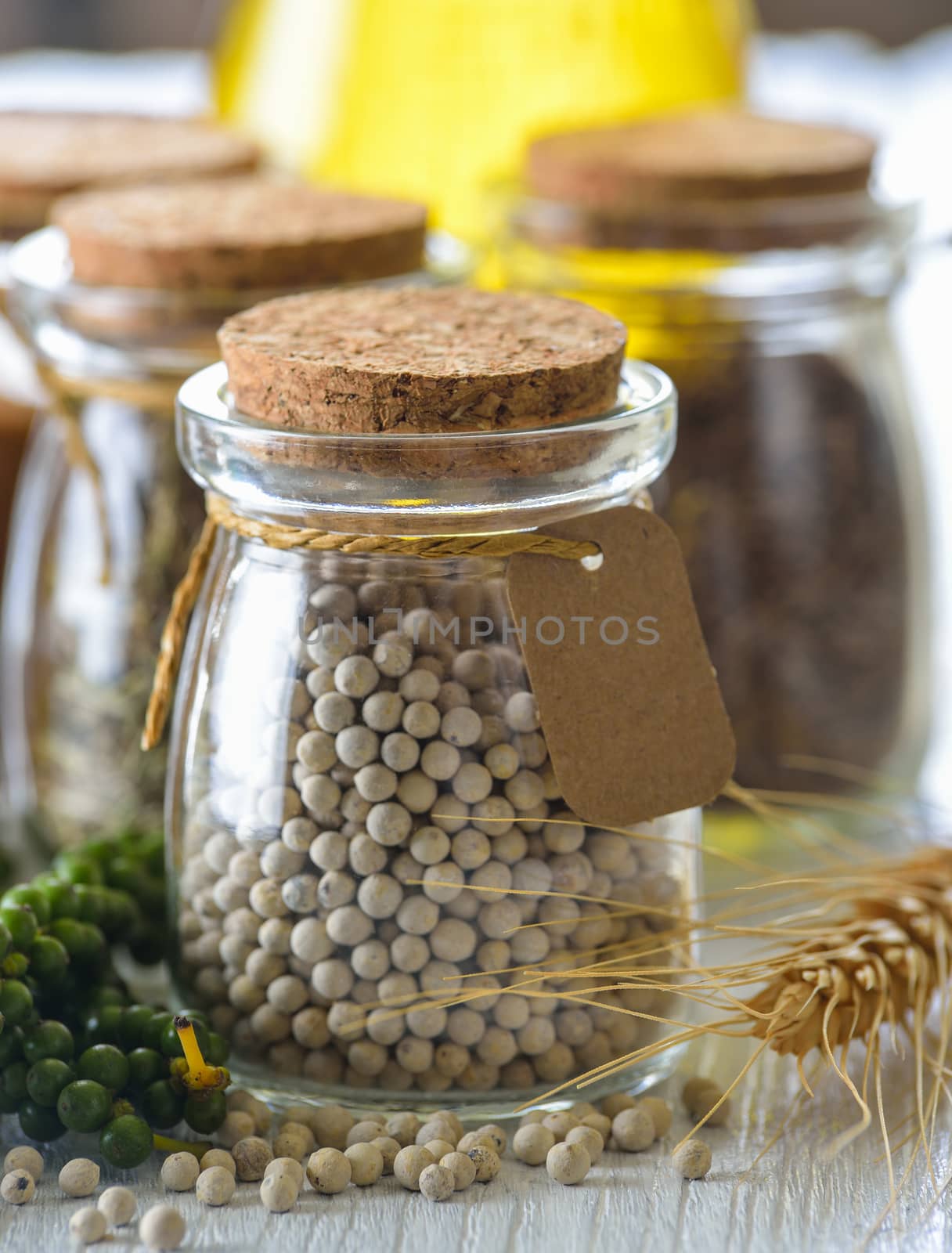 peppercorn in bottle on table by sommai