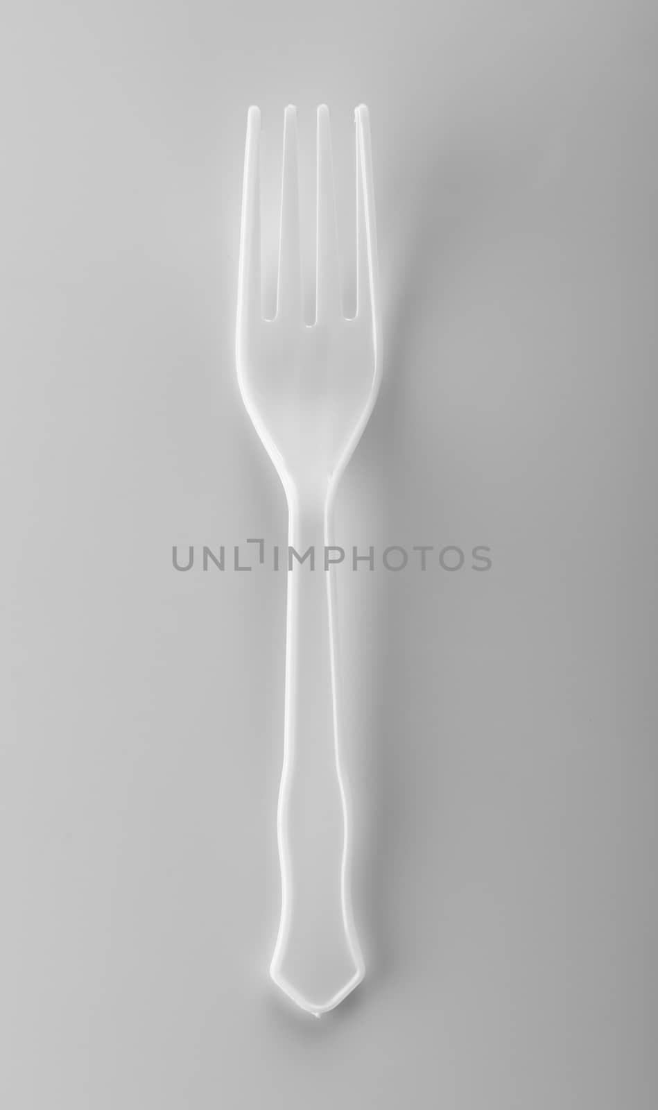 plastic forks on white background by sommai
