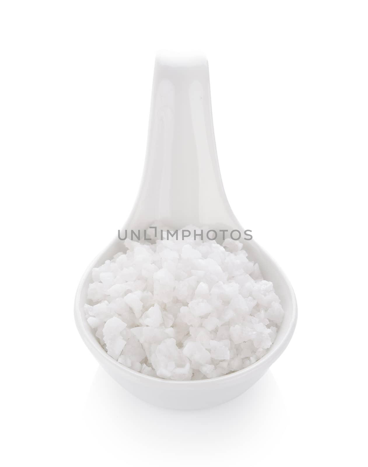 salt in spoon on white background by sommai