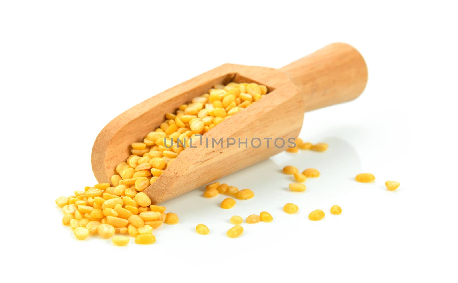 Green beans sees in wood scoop on white background