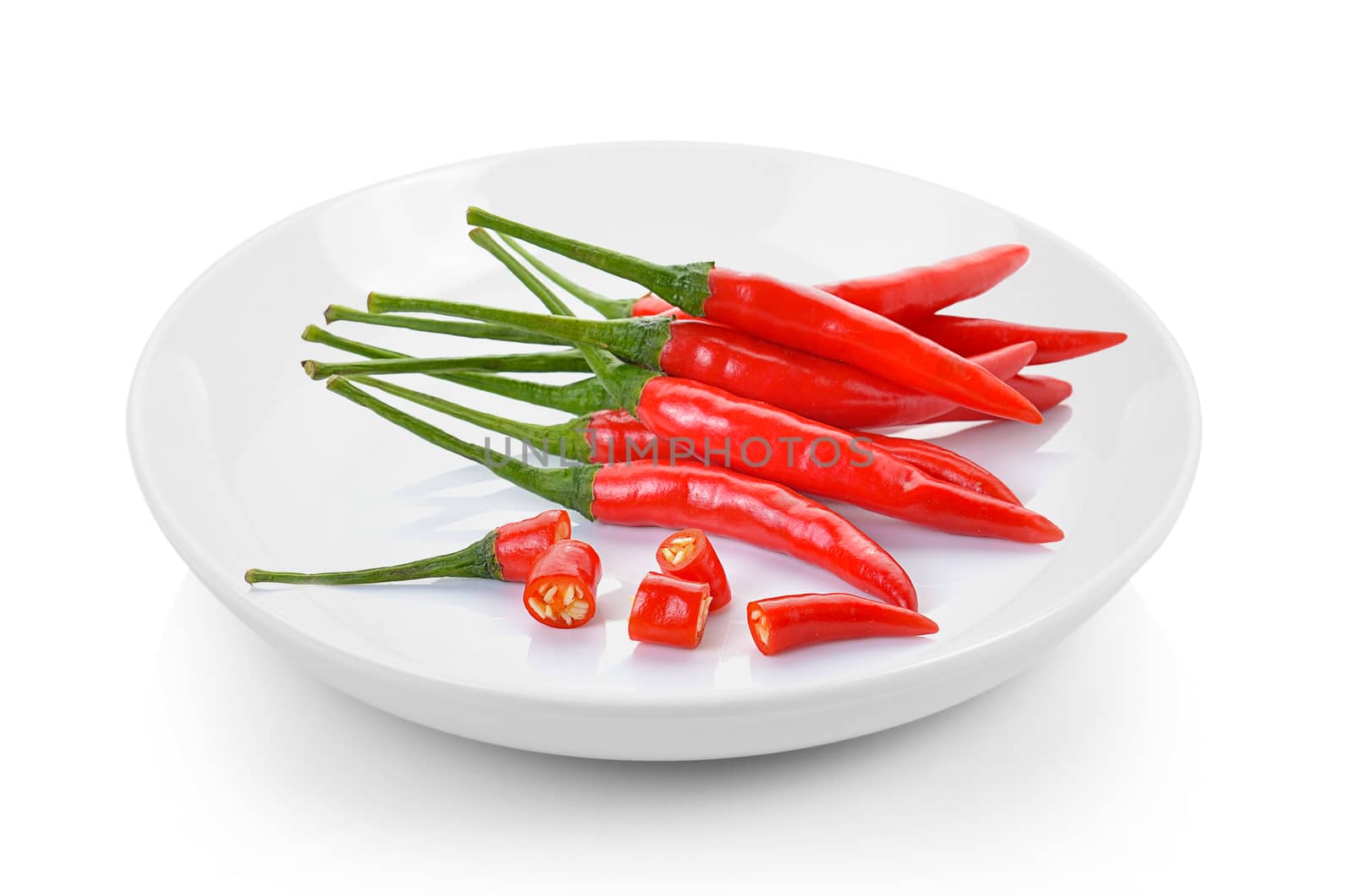 red chili peppers in plate on white background by sommai