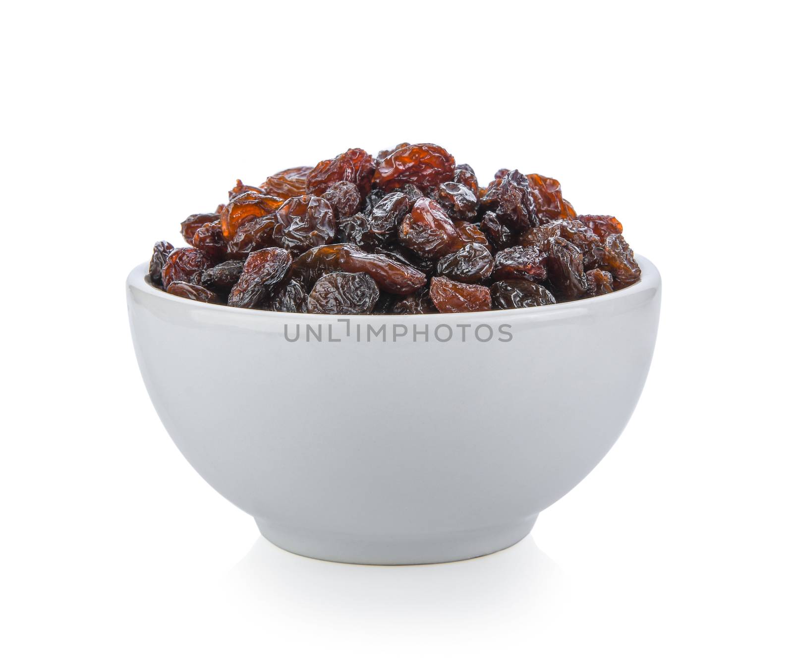Black raisin on white bowl isolated on white background by sommai