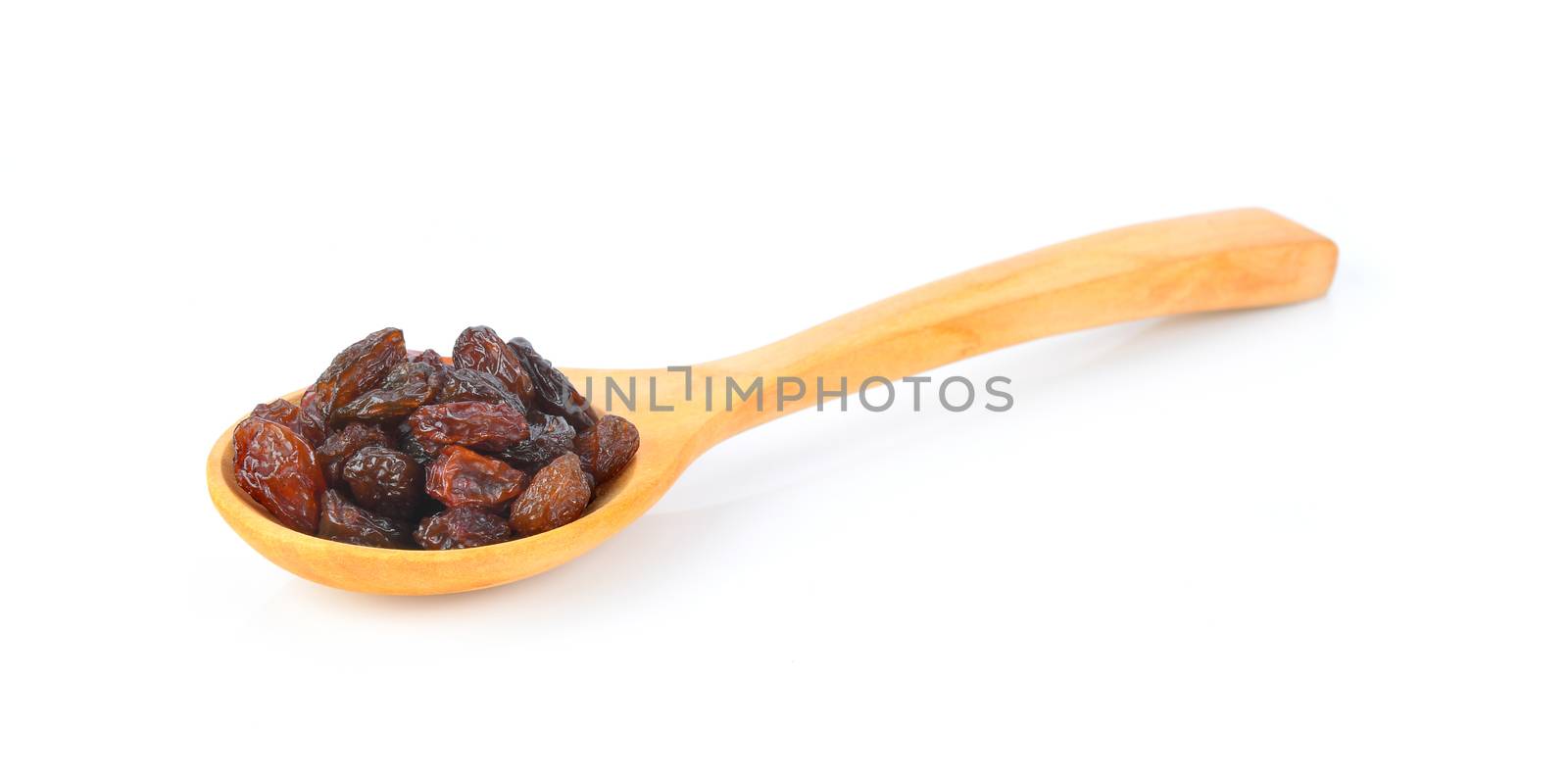 raisin in wood spoon isolated on white background