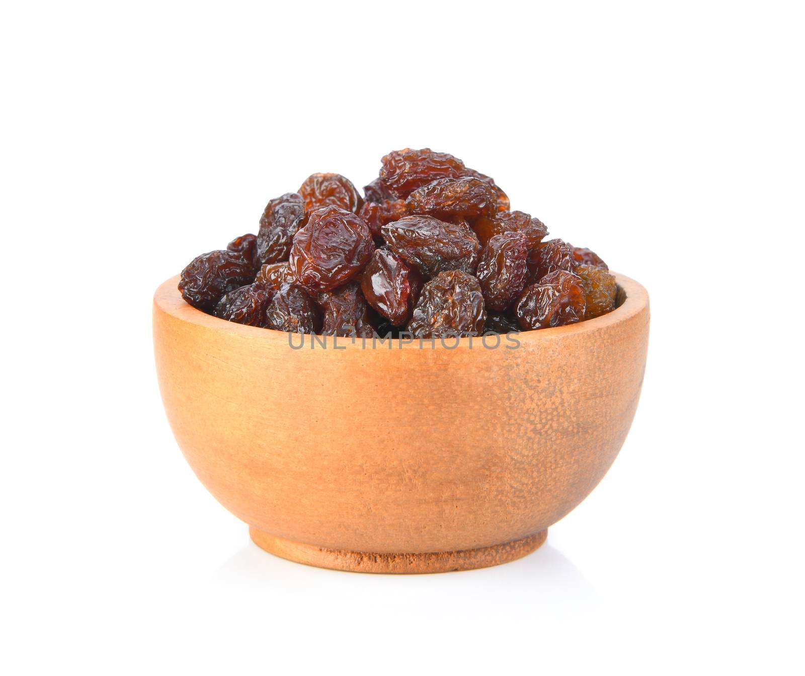 raisin on wood bowl isolated on white background