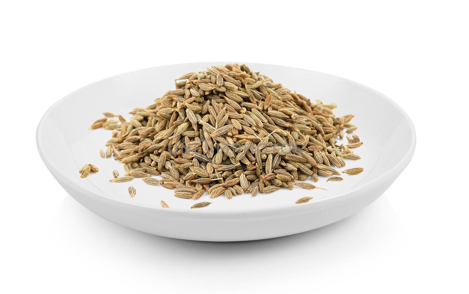 cumin seeds in plate on white background by sommai