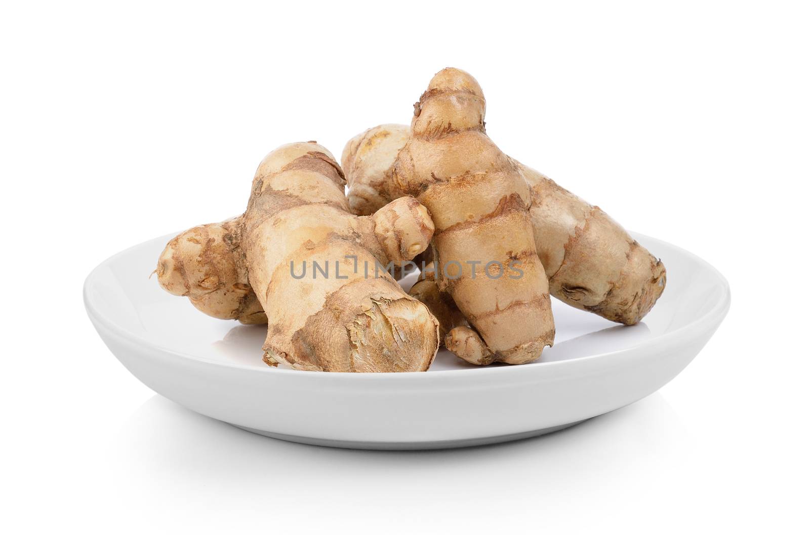 fresh turmeric  in plate on white background by sommai