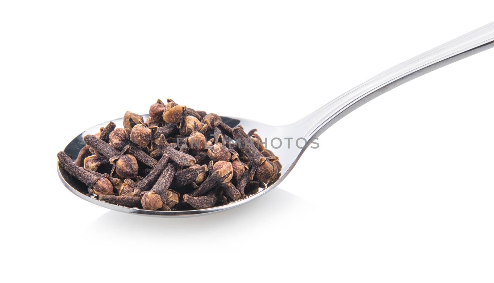 cloves spices in spoon on white background