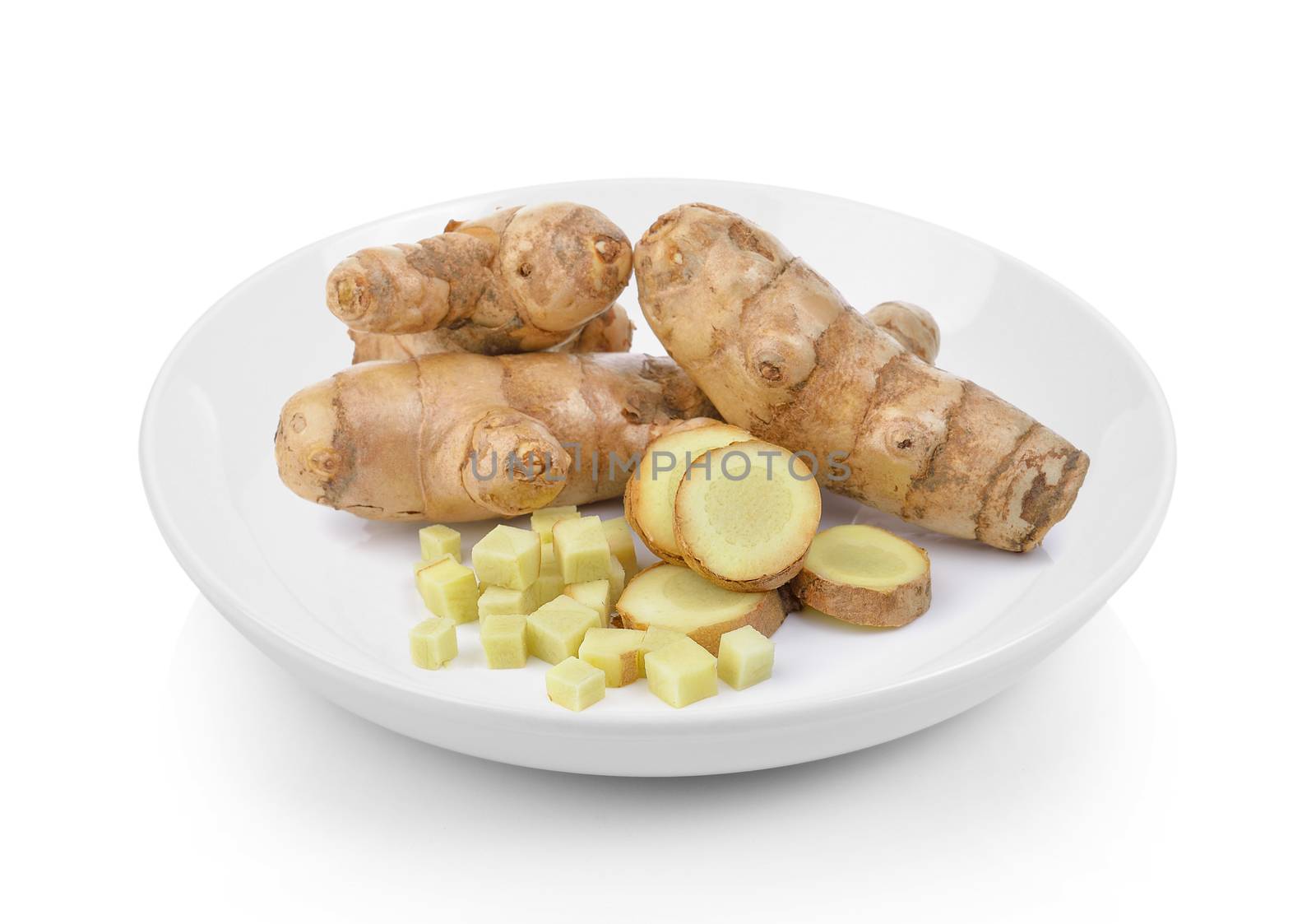 fresh turmeric in plate on white background by sommai