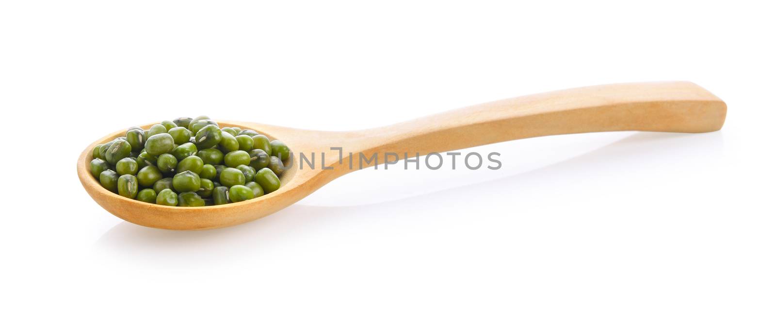 Green beans seeds in wood spoon on white background