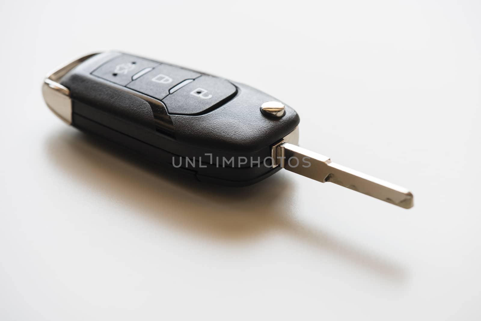 Close up of Remote electronic car key with mechanical second opening on white background.