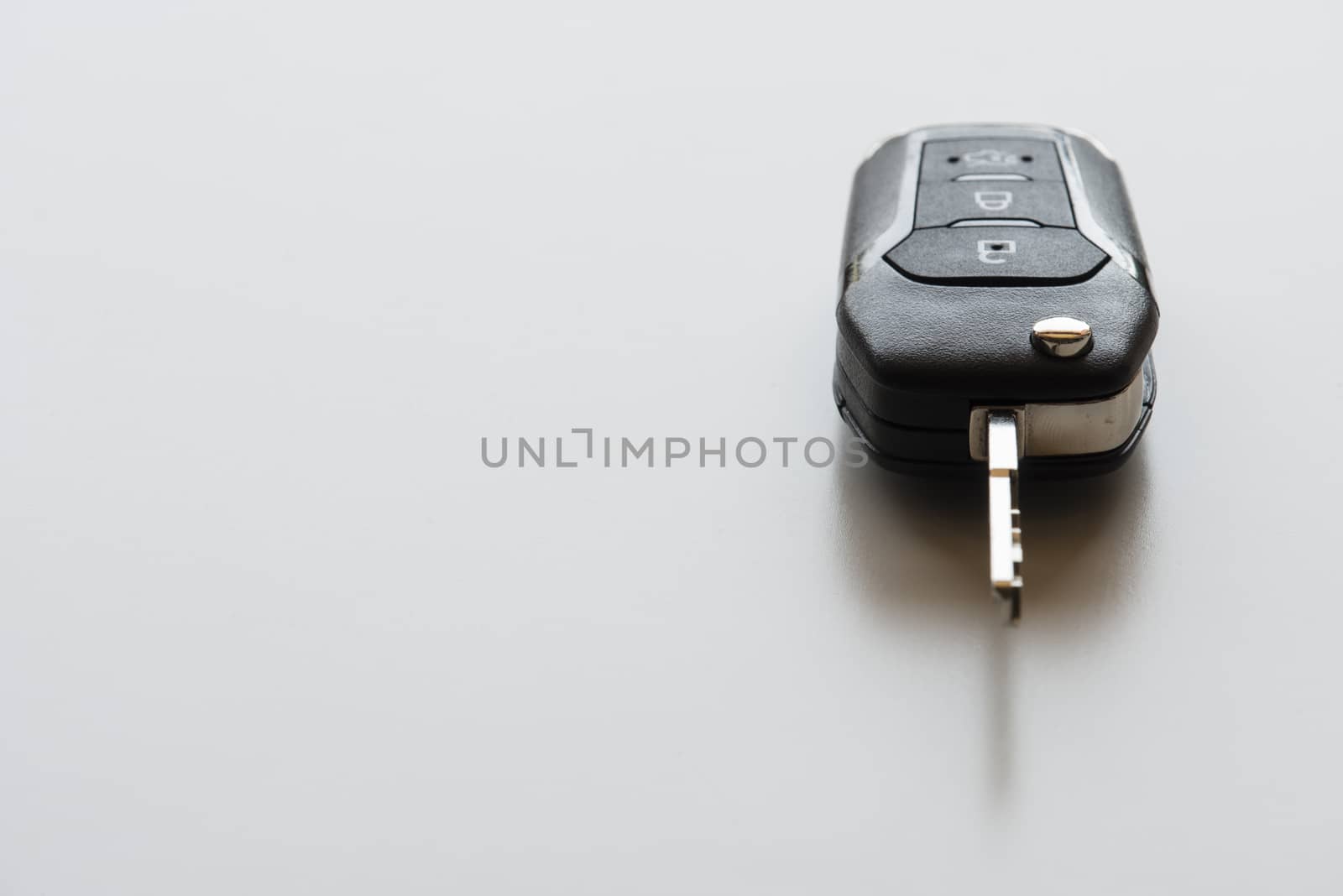 Close up of Remote electronic car key with mechanical second opening on white background.