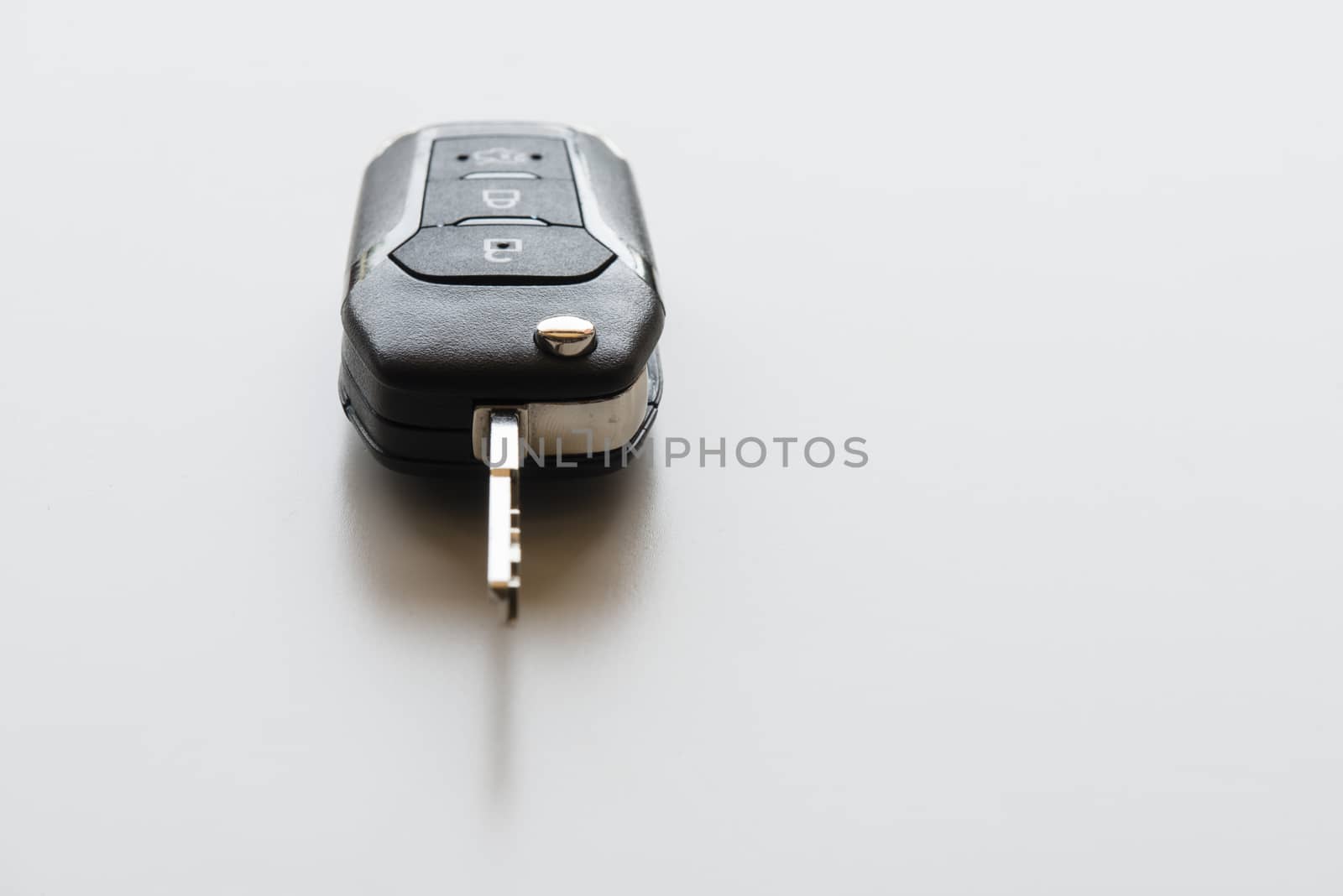 Close up of Remote electronic car key with mechanical second opening on white background.