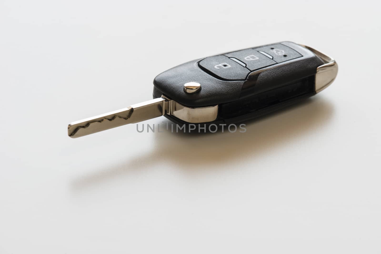 Close up of Remote electronic car key with mechanical second opening on white background.