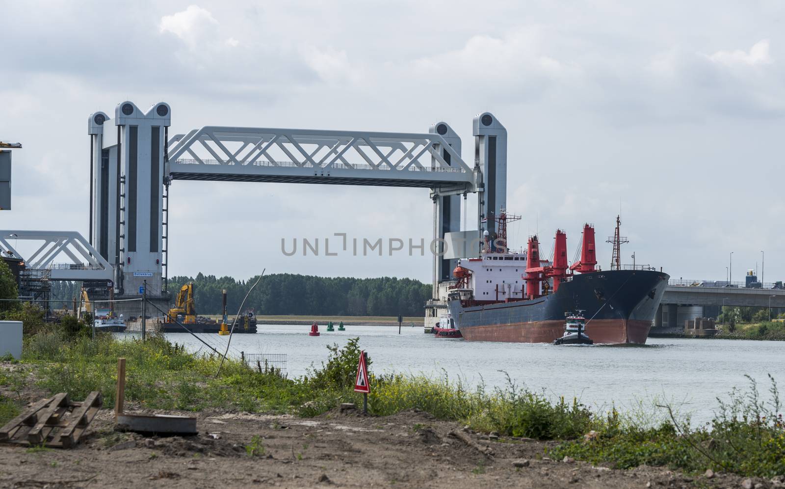 Botlek Bridge in the Rotterdam harbor area. The Botlek bridge is a combined lift over the Old Maas river, open to let a ship throughin the harbor of Rotterdam, famous by a lot of malfunction of it,