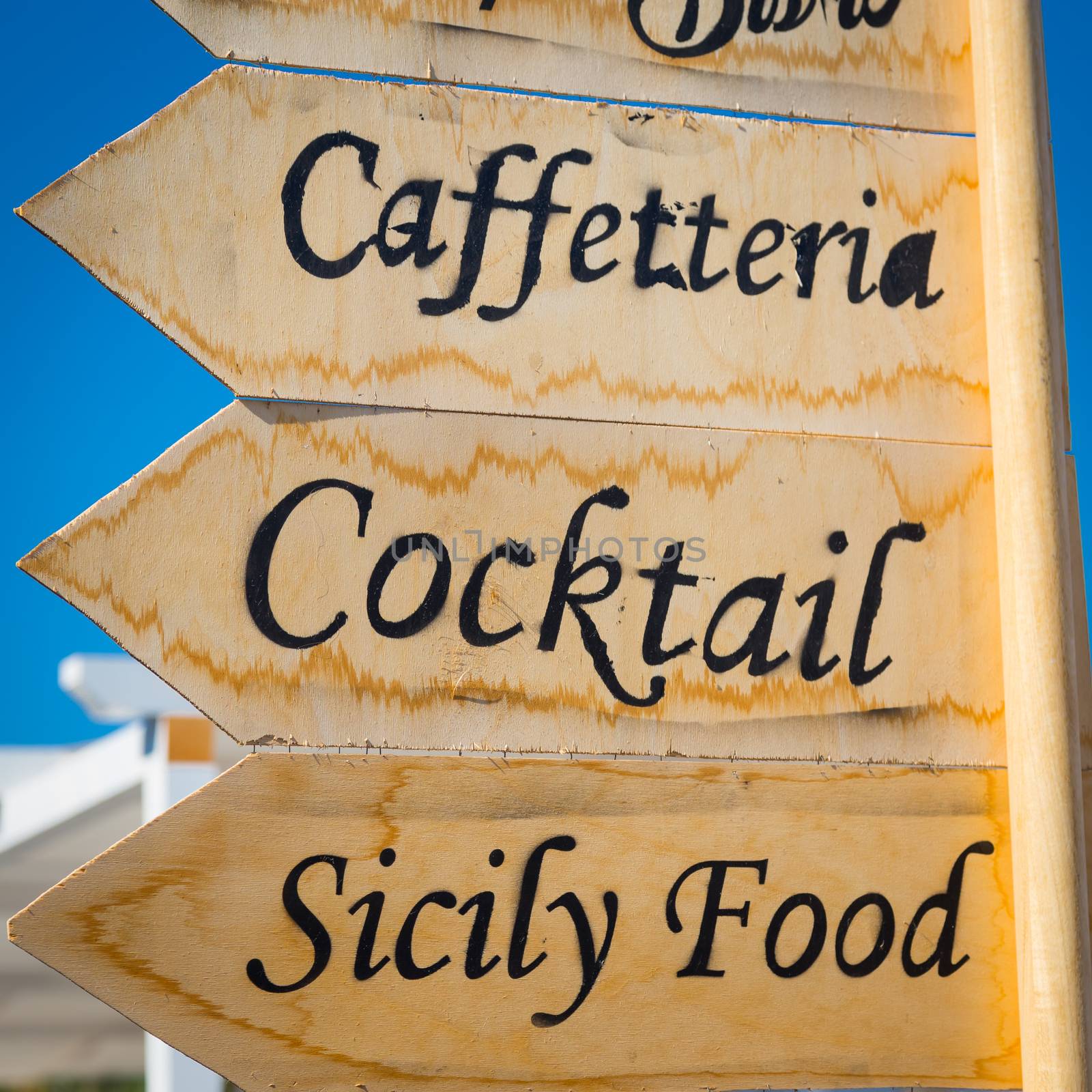 Marzamemi, small town in south of Siciliy, Italy. Sign made of wood with direction to local restaurant.