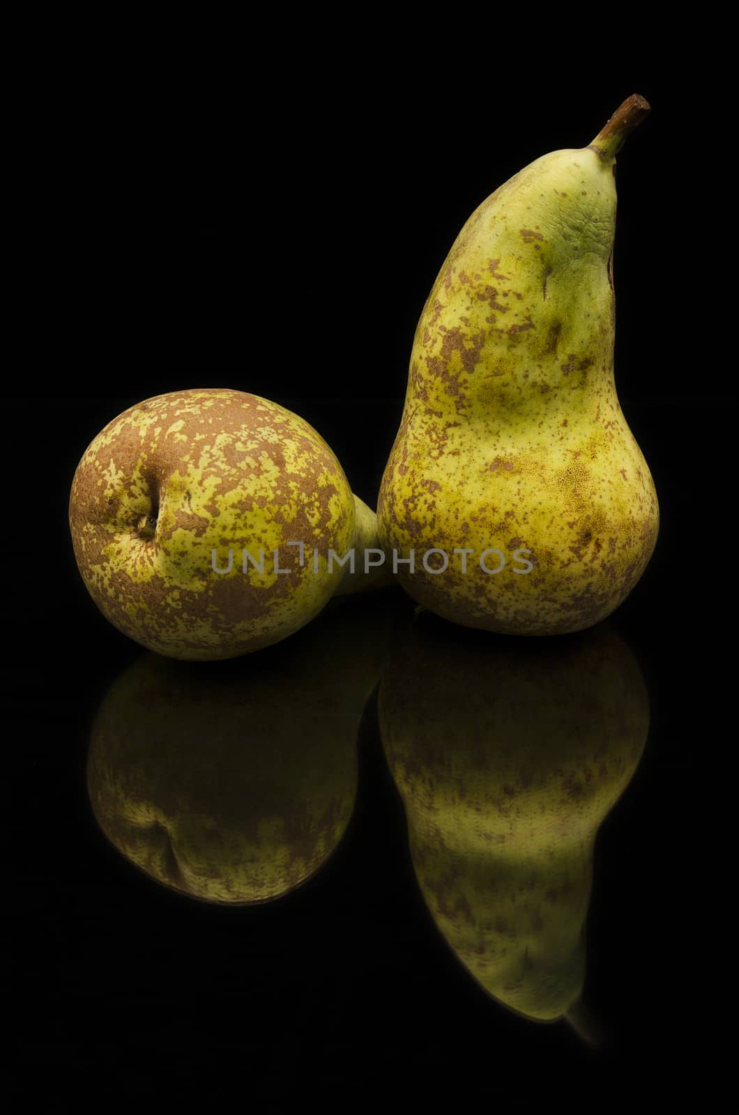 Brown pears on black isolated background by HERRAEZ