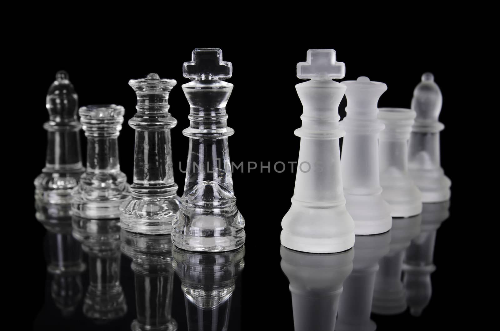Chess pieces isolated on black background. Beautiful reflection composition by HERRAEZ