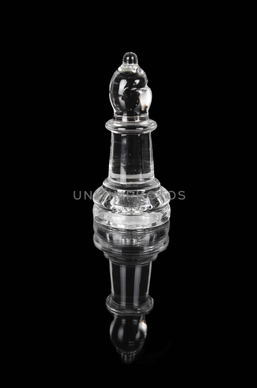 Glass chess bishop on black isolated background. by HERRAEZ